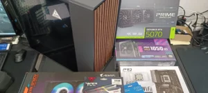 Gaming computer kabinet og hardware komponenter på arbejdsbord.